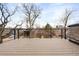 Outdoor deck with a wood floor and metal railings showcases neighborhood views at 2231 W 36Th Ave, Denver, CO 80211