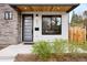 Contemporary home featuring a modern front door, stone accents, and natural wood ceiling at 2231 W 36Th Ave, Denver, CO 80211