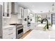 Bright, modern kitchen featuring a large island, stainless steel appliances, and stylish backsplash at 2231 W 36Th Ave, Denver, CO 80211
