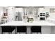 Bright, modern kitchen boasts a large island, white cabinets, and stainless steel appliances at 2231 W 36Th Ave, Denver, CO 80211