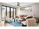 Stylish living room featuring modern furniture, hardwood floors, and large sliding glass doors to the outdoor space at 2231 W 36Th Ave, Denver, CO 80211