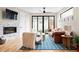 Bright living room featuring a stone fireplace, hardwood floors, modern furniture and sliding glass doors to the backyard at 2231 W 36Th Ave, Denver, CO 80211