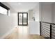 Bright living room with hardwood floors, modern railing, and balcony access at 2231 W 36Th Ave, Denver, CO 80211