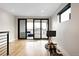 Bright living room with hardwood floors, gym equipment and balcony access at 2231 W 36Th Ave, Denver, CO 80211