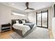 Serene main bedroom featuring a large bed, ceiling fan, and access to a private balcony with natural light at 2231 W 36Th Ave, Denver, CO 80211