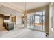 Bright kitchen with stainless appliances, gray wood floors, island, and sliding glass door to back patio at 13374 Blue Amber Ct, Parker, CO 80134
