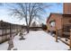 Backyard view with snow, wooden fence and small fountain at 7900 E Dartmouth Ave # 76, Denver, CO 80231