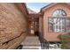 Brick front entryway with steps leading to a wood door at 7900 E Dartmouth Ave # 76, Denver, CO 80231