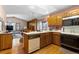 Kitchen with island, wood cabinets, and breakfast nook at 7900 E Dartmouth Ave # 76, Denver, CO 80231