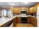 Galley kitchen with wood cabinets and tile countertops at 7900 E Dartmouth Ave # 76, Denver, CO 80231