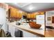 Kitchen boasts wood cabinets, tile countertops, and breakfast bar at 7900 E Dartmouth Ave # 76, Denver, CO 80231