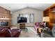 Living room with brick fireplace and large windows at 7900 E Dartmouth Ave # 76, Denver, CO 80231