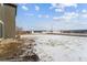 Snowy backyard with open space and distant views of houses at 996 Kolz Pt, Elizabeth, CO 80107