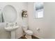 Clean and bright bathroom with pedestal sink and toilet at 996 Kolz Pt, Elizabeth, CO 80107