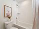 Clean bathroom with a bathtub, toilet, and white tile at 996 Kolz Pt, Elizabeth, CO 80107