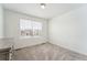 Neutral bedroom with a window and a gray dresser at 996 Kolz Pt, Elizabeth, CO 80107