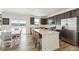 Bright kitchen featuring an island with bar seating, stainless steel appliances, and a sliding glass door to the outside at 996 Kolz Pt, Elizabeth, CO 80107