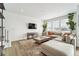 Bright living room featuring a large sectional sofa, a coffee table, and a view to the outside at 996 Kolz Pt, Elizabeth, CO 80107