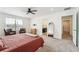 Bright main bedroom with ceiling fan, sitting area, and ensuite bathroom and walk-in closet at 996 Kolz Pt, Elizabeth, CO 80107