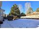 Large backyard with stone wall and snow at 21475 Grays Peak Dr, Parker, CO 80138