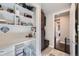 Organized mudroom with built-in bench, shelving, and workspace at 11364 Birolli Pl, Littleton, CO 80125