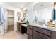 Bright bathroom with granite countertop vanity and walk-in closet entrance at 1043 High Point Trl, Elizabeth, CO 80107