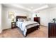 Inviting bedroom with neutral carpet, a tray ceiling, and windows with neighborhood views at 1043 High Point Trl, Elizabeth, CO 80107