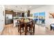 Modern kitchen with stainless steel appliances, dark cabinets, and an adjacent dining area at 1043 High Point Trl, Elizabeth, CO 80107