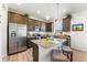 Bright kitchen featuring stainless steel appliances, granite counters, and a kitchen island with seating at 1043 High Point Trl, Elizabeth, CO 80107