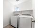 Clean and bright laundry room with a side-by-side washer and dryer and a built-in shelf at 1043 High Point Trl, Elizabeth, CO 80107