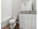 Modern bathroom with a white toilet, tub, and a granite countertop vanity at 2184 Alyssa St, Fort Lupton, CO 80621