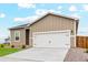 Single-Gathering home with well-maintained lawn, rock garden, and a two-car garage at 2184 Alyssa St, Fort Lupton, CO 80621