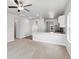 Open-concept living room with plush carpeting flowing into the modern kitchen at 2184 Alyssa St, Fort Lupton, CO 80621