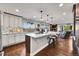 Open concept kitchen with island and hardwood floors at 6238 W 80Th Pl, Arvada, CO 80003