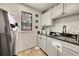 Bright laundry room with washer, dryer, and built-in cabinets at 6238 W 80Th Pl, Arvada, CO 80003