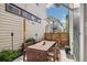 This backyard boasts a dining table with seating for six, as well as tasteful foliage and string lights at 1702 W 66Th Ave, Denver, CO 80221