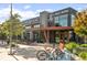 Exterior view of Bruz Beers featuring Belgian-inspired ales, outdoor seating, and bike racks at 1702 W 66Th Ave, Denver, CO 80221