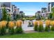 Beautifully landscaped common area with decorative grasses and walking paths between modern townhome buildings at 1702 W 66Th Ave, Denver, CO 80221