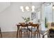 Dining area featuring a wood table with modern lighting and a sliding glass door at 1702 W 66Th Ave, Denver, CO 80221