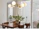 Cozy dining area with modern chandelier, hardwood floors, and natural light at 1702 W 66Th Ave, Denver, CO 80221