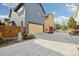 This home boasts a light yellow garage door and a driveway, adding to the home's curb appeal at 1702 W 66Th Ave, Denver, CO 80221