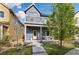 Charming blue two-story home with a inviting front porch and balcony, perfect for relaxing outdoors at 1702 W 66Th Ave, Denver, CO 80221