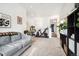Versatile flex space featuring a gray couch, exercise bike, and open layout at 1702 W 66Th Ave, Denver, CO 80221