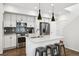 Modern kitchen with sleek stainless-steel appliances, a spacious island, and pendant lighting at 1702 W 66Th Ave, Denver, CO 80221