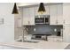 Bright kitchen showcasing stainless steel appliances, granite countertops, and ample cabinet space at 1702 W 66Th Ave, Denver, CO 80221