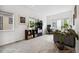Bright and airy living room with a large window, black storage shelving, and potted plants at 1702 W 66Th Ave, Denver, CO 80221