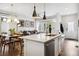 Open concept living space featuring a modern kitchen, dining area, and comfortable seating at 1702 W 66Th Ave, Denver, CO 80221