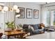 Bright living space featuring dining area with modern lighting and a comfortable gray couch at 1702 W 66Th Ave, Denver, CO 80221