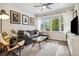 Cozy living room with stylish gray couch, glass coffee table, light-colored rug, and bright natural light at 1702 W 66Th Ave, Denver, CO 80221