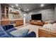 Stylish living room with a wet bar, sleek wooden cabinetry, and comfortable seating, perfect for entertaining or relaxation at 1702 W 66Th Ave, Denver, CO 80221